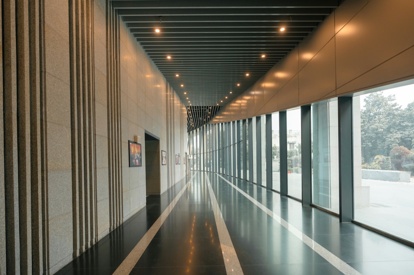 A long, sunlit corridor with strong leading lines disappearing into the distance